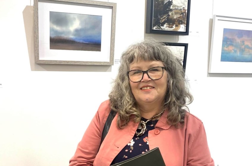 Site icon photo of Janine in a pink jacket